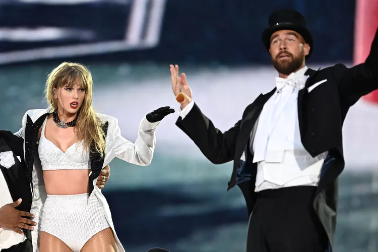 Travis Kelce and Taylor Swift onstage at her concert
